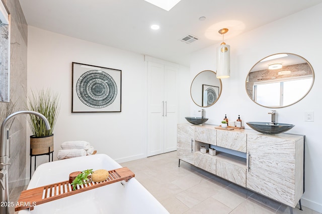 2942 N 81st Pl, Scottsdale, AZ 85251 - bathroom featuring a bathing tub, vanity, and tile patterned floors