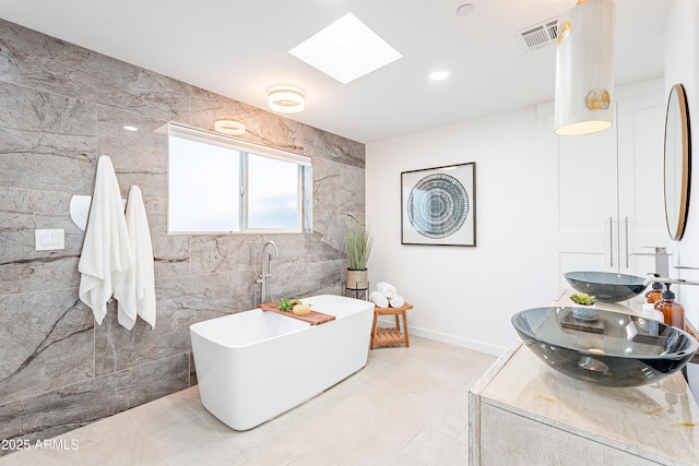 2942 N 81st Pl, Scottsdale, AZ 85251 - bathroom featuring a bath, a skylight, and tile walls
