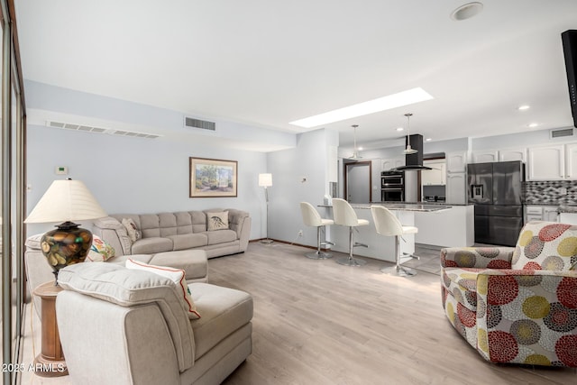 7252 E Edgewood Ave, Mesa, AZ 85208 - living room with visible vents, recessed lighting, and light wood-type flooring