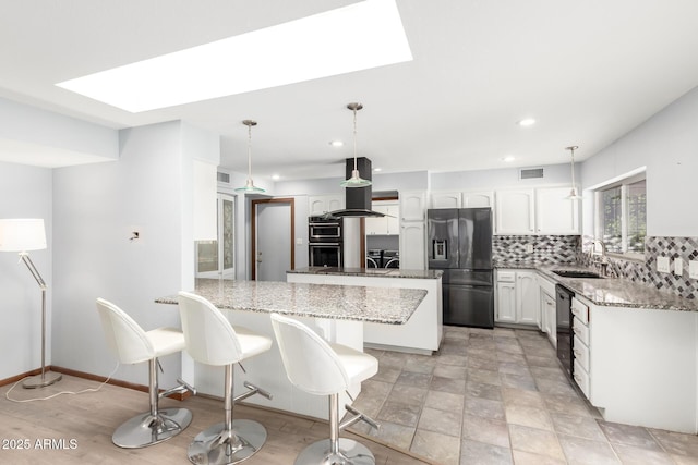 7252 E Edgewood Ave, Mesa, AZ 85208 - kitchen with a sink, fridge with ice dispenser, backsplash, and a skylight