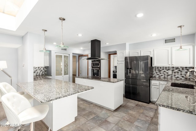 7252 E Edgewood Ave, Mesa, AZ 85208 - kitchen featuring island exhaust hood, a peninsula, dark stone counters, a sink, and black appliances