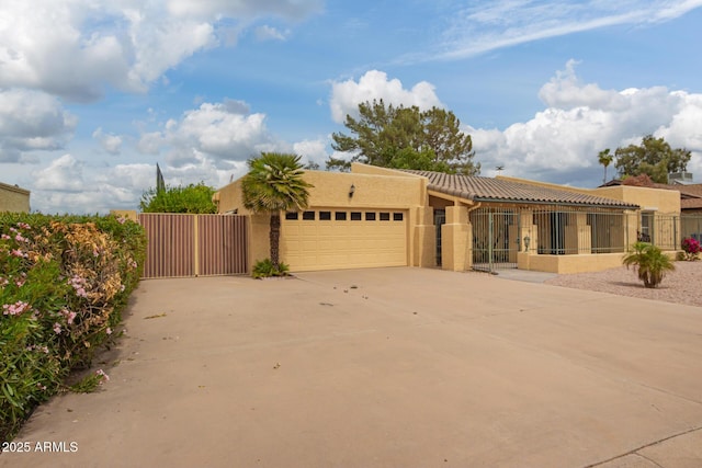 7252 E Edgewood Ave, Mesa, AZ 85208 - pueblo revival-style home featuring fence, a garage, concrete driveway, a tile roof, and stucco siding