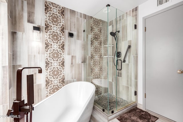 7252 E Edgewood Ave, Mesa, AZ 85208 - full bathroom with a soaking tub, a stall shower, tile walls, and visible vents