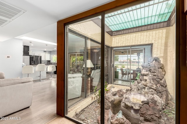 7252 E Edgewood Ave, Mesa, AZ 85208 - doorway to outside featuring light wood-style flooring and visible vents