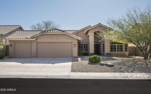 18873 N 94th Way, Scottsdale, AZ 85255 - view of front facade with an attached garage, stucco siding, driveway, and a tile roof