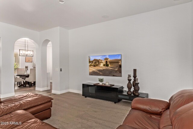 4667 E Reins Rd, Gilbert, AZ 85297 - living area featuring arched walkways, baseboards, and a chandelier