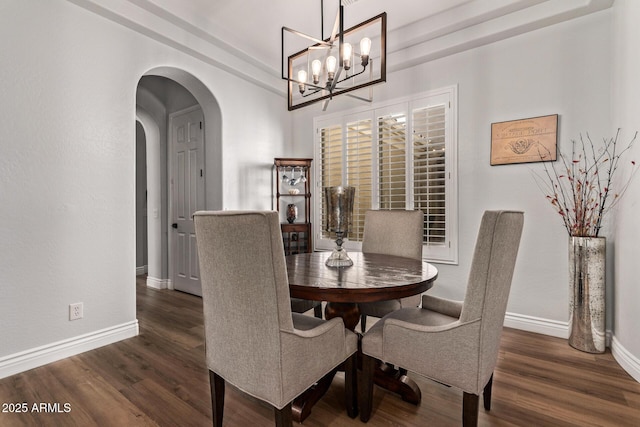 4667 E Reins Rd, Gilbert, AZ 85297 - dining space with arched walkways, a chandelier, wood finished floors, and baseboards