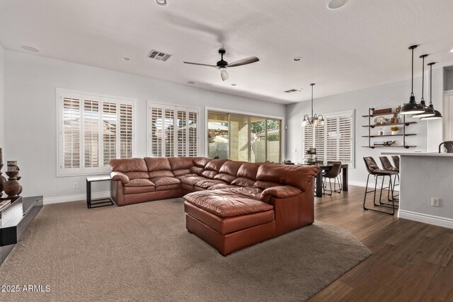 4667 E Reins Rd, Gilbert, AZ 85297 - living area featuring baseboards, ceiling fan, a chandelier, and dark wood-style floors