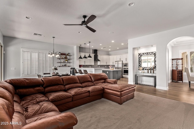 4667 E Reins Rd, Gilbert, AZ 85297 - living room with ceiling fan, arched walkways, a chandelier, recessed lighting, and wood finished floors