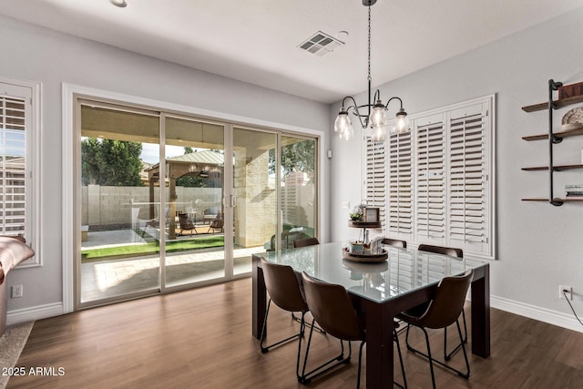 4667 E Reins Rd, Gilbert, AZ 85297 - dining space featuring a chandelier, plenty of natural light, dark wood-style floors, and baseboards