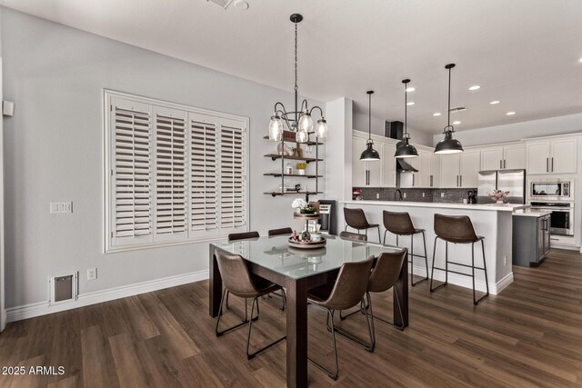 4667 E Reins Rd, Gilbert, AZ 85297 - dining space featuring dark wood-style floors, a chandelier, recessed lighting, and baseboards