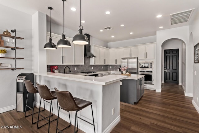4667 E Reins Rd, Gilbert, AZ 85297 - kitchen with appliances with stainless steel finishes, wall chimney exhaust hood, light countertops, baseboards, and decorative backsplash