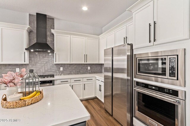4667 E Reins Rd, Gilbert, AZ 85297 - kitchen with stainless steel appliances, wall chimney exhaust hood, white cabinetry, decorative backsplash, and recessed lighting