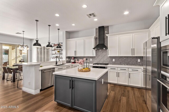 4667 E Reins Rd, Gilbert, AZ 85297 - kitchen featuring appliances with stainless steel finishes, wall chimney range hood, a sink, white cabinets, and recessed lighting