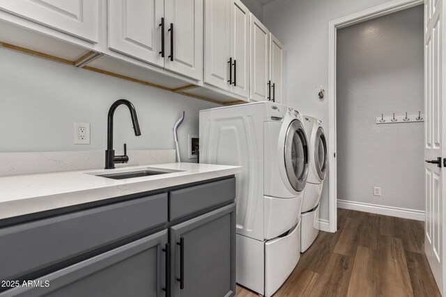 4667 E Reins Rd, Gilbert, AZ 85297 - washroom with washer and clothes dryer, cabinet space, dark wood finished floors, and baseboards