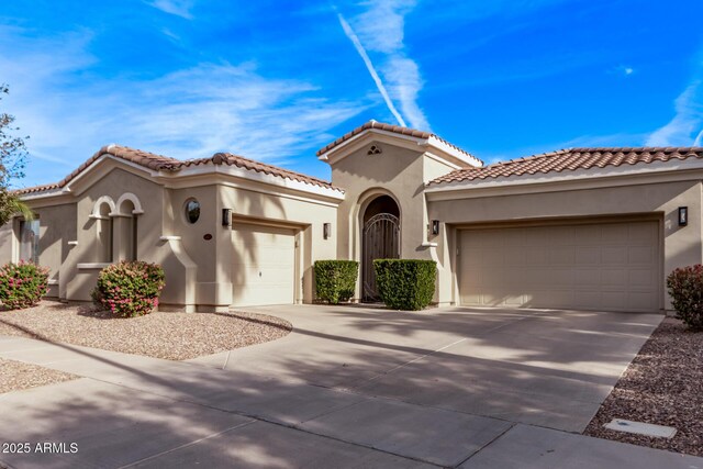 4667 E Reins Rd, Gilbert, AZ 85297 - mediterranean / spanish-style house with an attached garage, stucco siding, concrete driveway, and a tiled roof