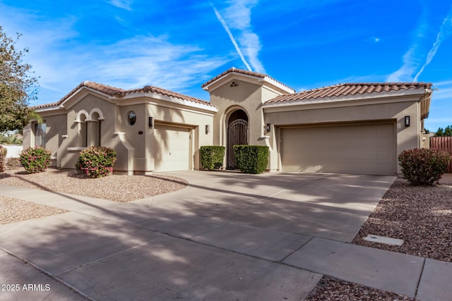 4667 E Reins Rd, Gilbert, AZ 85297 - mediterranean / spanish-style house with a garage, stucco siding, driveway, and a tile roof
