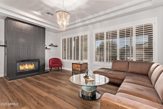 4667 E Reins Rd, Gilbert, AZ 85297 - living room featuring a raised ceiling, baseboards, wood finished floors, and a chandelier