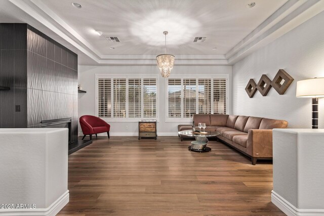 4667 E Reins Rd, Gilbert, AZ 85297 - living area featuring wood finished floors, a chandelier, a tray ceiling, and baseboards