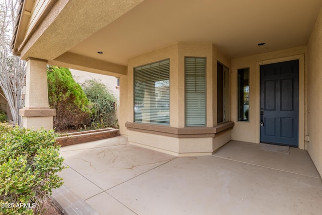 view of exterior entry featuring a patio