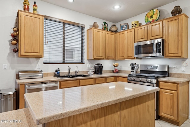 kitchen featuring light stone counters, a center island, sink, and stainless steel appliances