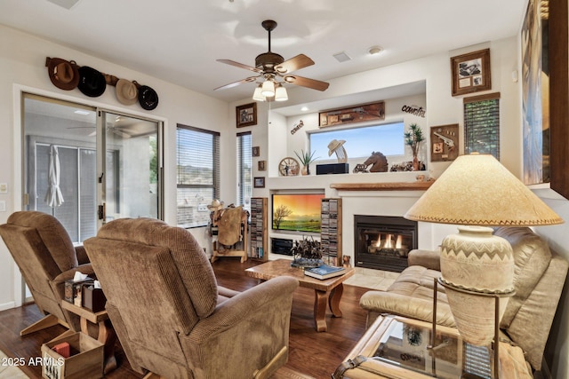 living room with hardwood / wood-style flooring and ceiling fan