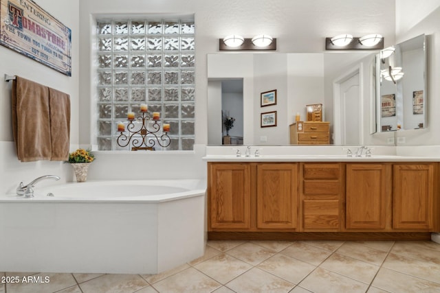 bathroom with tile patterned flooring, vanity, and a bathing tub