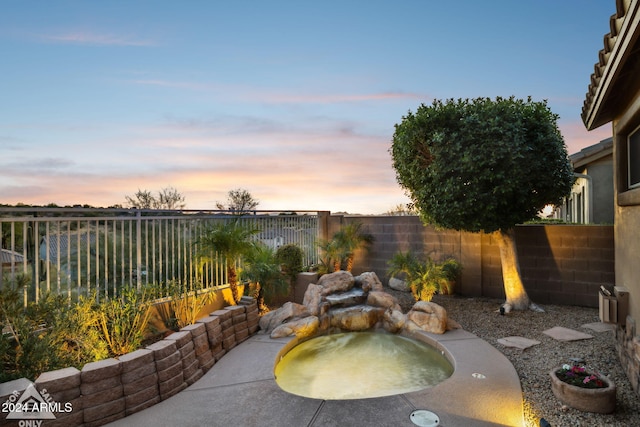 view of patio terrace at dusk