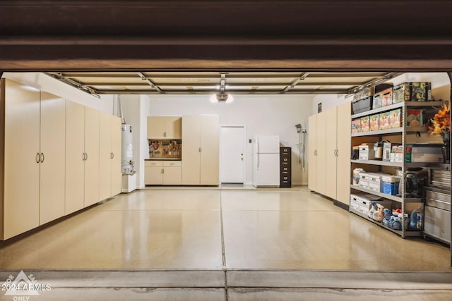 garage featuring white fridge and water heater