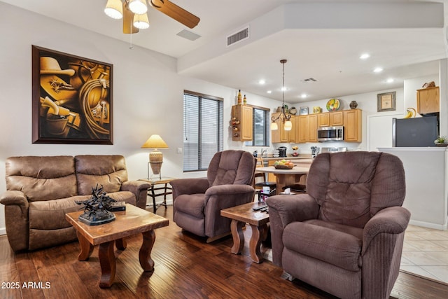 living room with wood-type flooring and ceiling fan