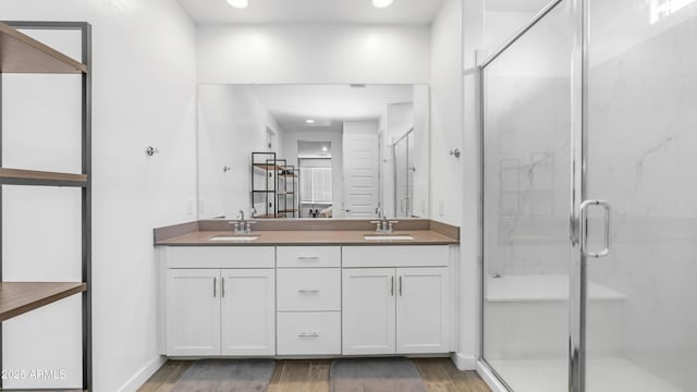 3117 E Hayfield Way, San Tan Valley, AZ 85140 - bathroom featuring wood finished floors, a marble finish shower, double vanity, and recessed lighting