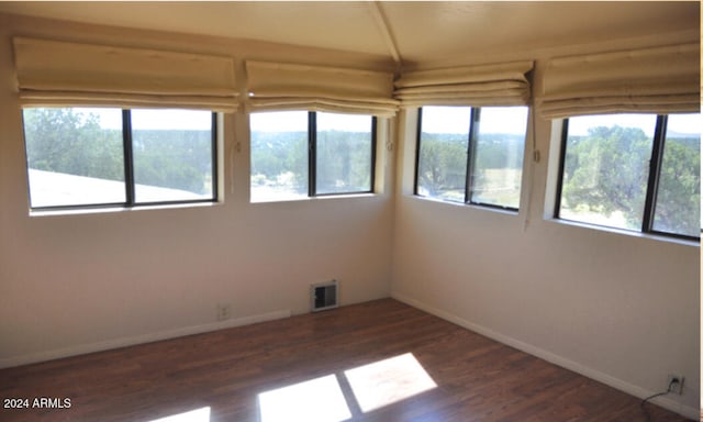 unfurnished room featuring dark wood-type flooring