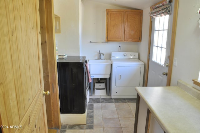 laundry area featuring cabinets, sink, washer / clothes dryer, and light tile patterned flooring