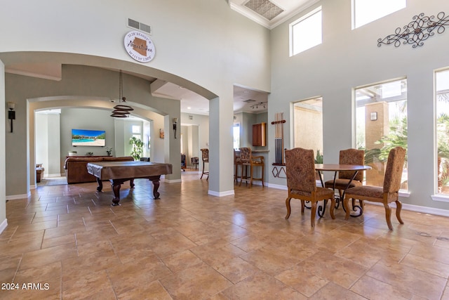 dining room with billiards, a wealth of natural light, ornamental molding, and ceiling fan