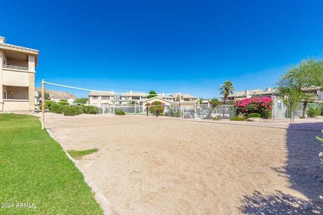 view of home's community with a yard and volleyball court