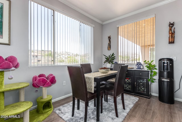 dining space with dark hardwood / wood-style flooring and crown molding