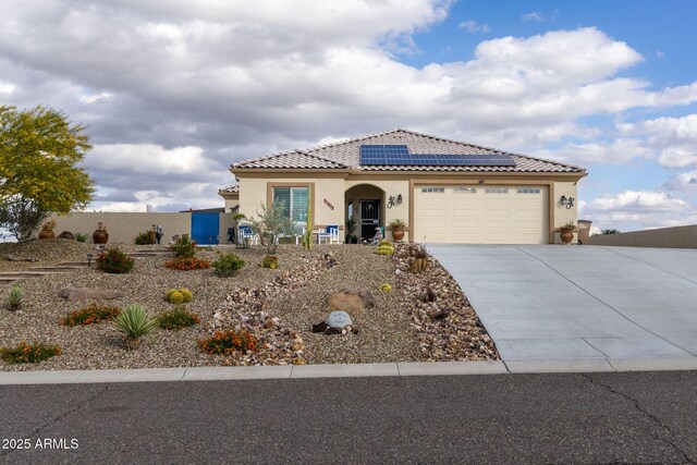 965 Calle Azul, Wickenburg, AZ 85390 - mediterranean / spanish-style house featuring concrete driveway, stucco siding, roof mounted solar panels, and a tiled roof