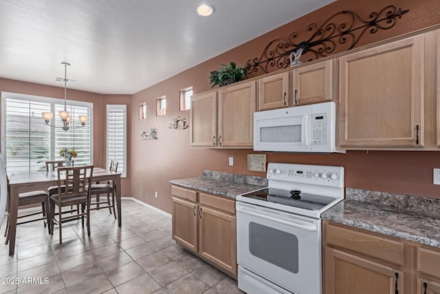 kitchen with a chandelier, light tile patterned floors, light brown cabinets, white appliances, and visible vents