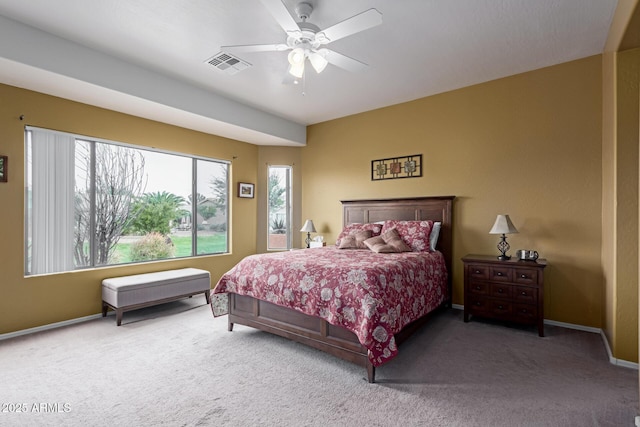 carpeted bedroom with visible vents, ceiling fan, and baseboards