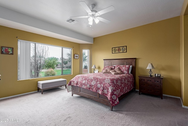 carpeted bedroom with visible vents, ceiling fan, and baseboards