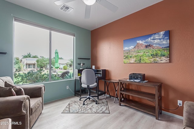 office featuring visible vents, ceiling fan, baseboards, and wood finished floors