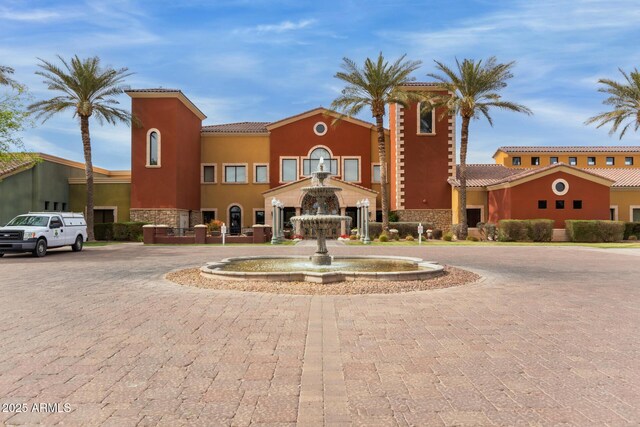 view of building exterior with curved driveway