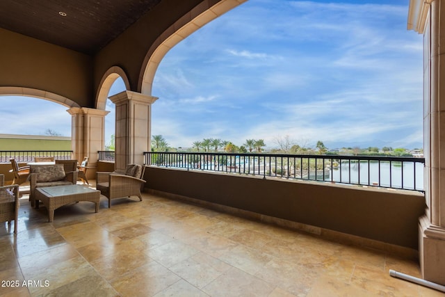 view of patio / terrace featuring a water view, a balcony, and an outdoor hangout area