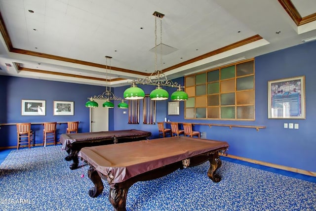 rec room with carpet floors, baseboards, a tray ceiling, and ornamental molding