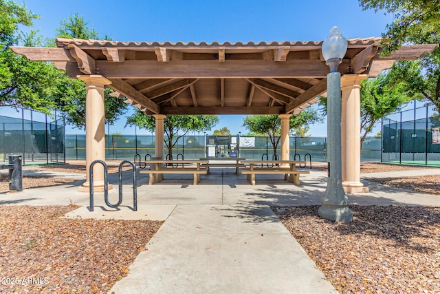 view of property's community with a gazebo and fence