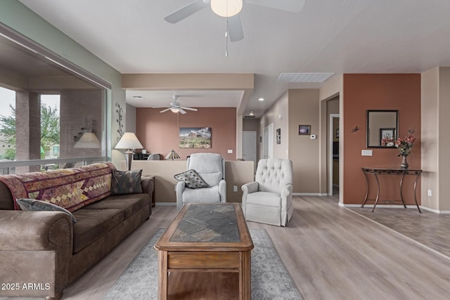 living room featuring recessed lighting, ceiling fan, light wood-style flooring, and baseboards