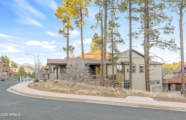 view of front facade with a mountain view and board and batten siding