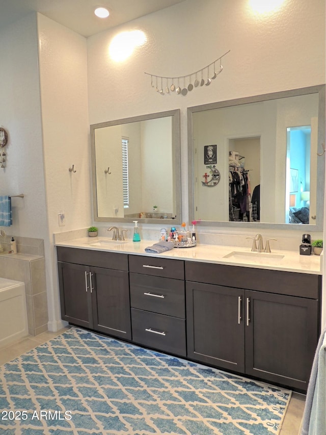 21696 E Arroyo Verde Dr, Queen Creek, AZ 85142 - bathroom featuring a sink, a tub to relax in, and double vanity