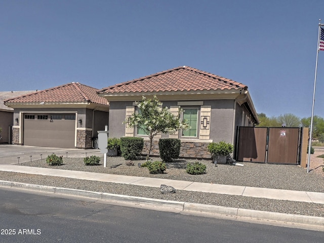 21696 E Arroyo Verde Dr, Queen Creek, AZ 85142 - view of front facade with a tiled roof, an attached garage, stone siding, and concrete driveway