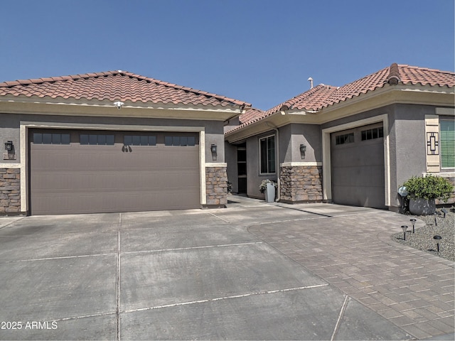21696 E Arroyo Verde Dr, Queen Creek, AZ 85142 - view of front of property with concrete driveway, stucco siding, stone siding, an attached garage, and a tiled roof